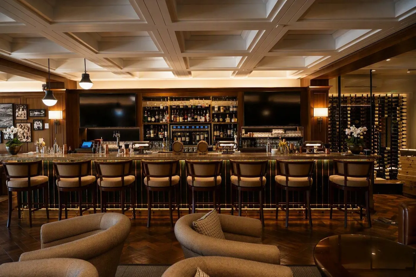 Millwork-paneled lounge with built-in bar and integrated lighting