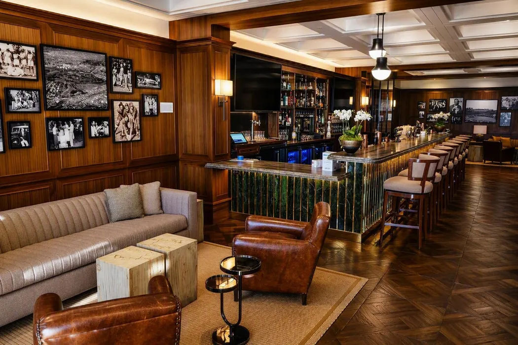 Wood-paneled lounge with integrated wine storage and ambient lighting